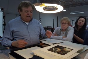 John Balkwill, owner of Lumino Press, sharing a project with SBP members Joyce and Yessy