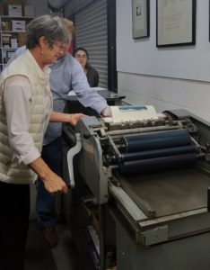 SBP member Elaine Le Vasseur operating the press with SBP member Colleen observing